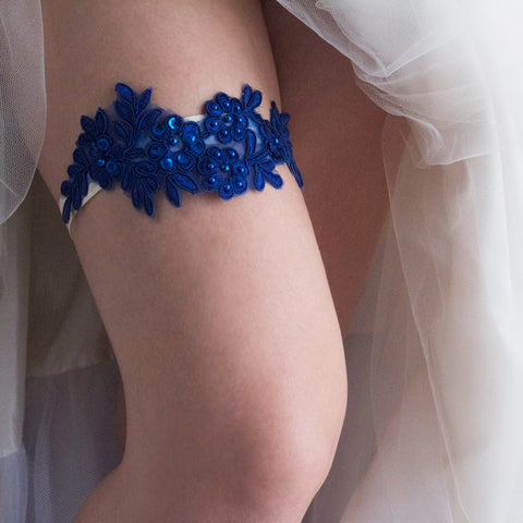 Blue Sapphire Color Wedding Garter Something Blue on Bride's Bent Leg in a Wedding Dress